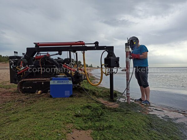 self propellered hydraulic screw pile installation machine making installation of geo piles on gulf coast